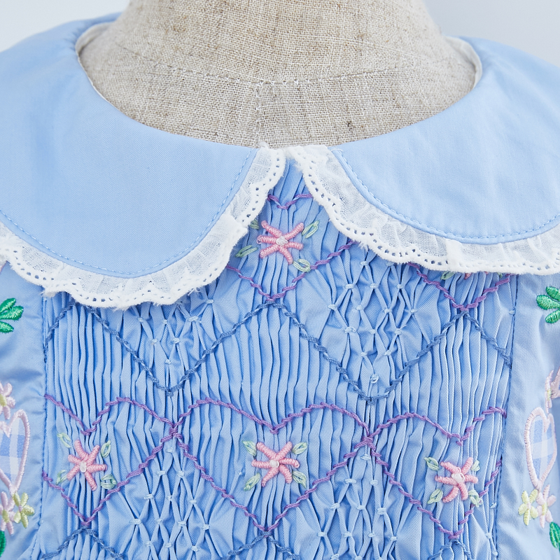 stunning detail with hannd smocked and embroidered